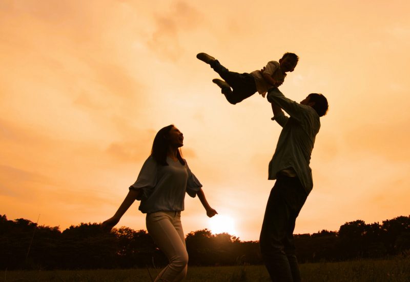silhouette of parent play with kid outdoor